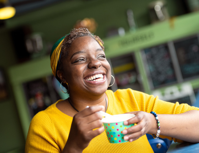 Student smiling, eating ice cream