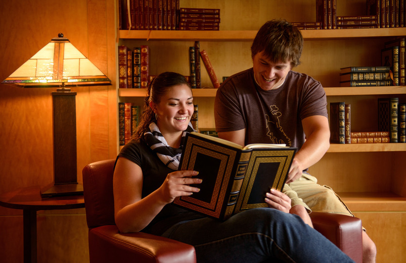 Two students looking at a book together