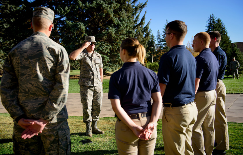 ROTC students stand at attention while learning their salute.