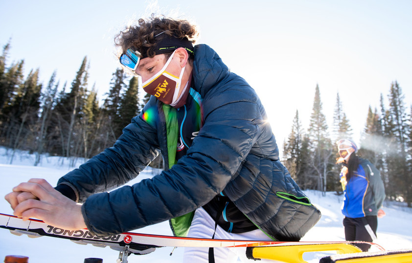 Student checking ski wax