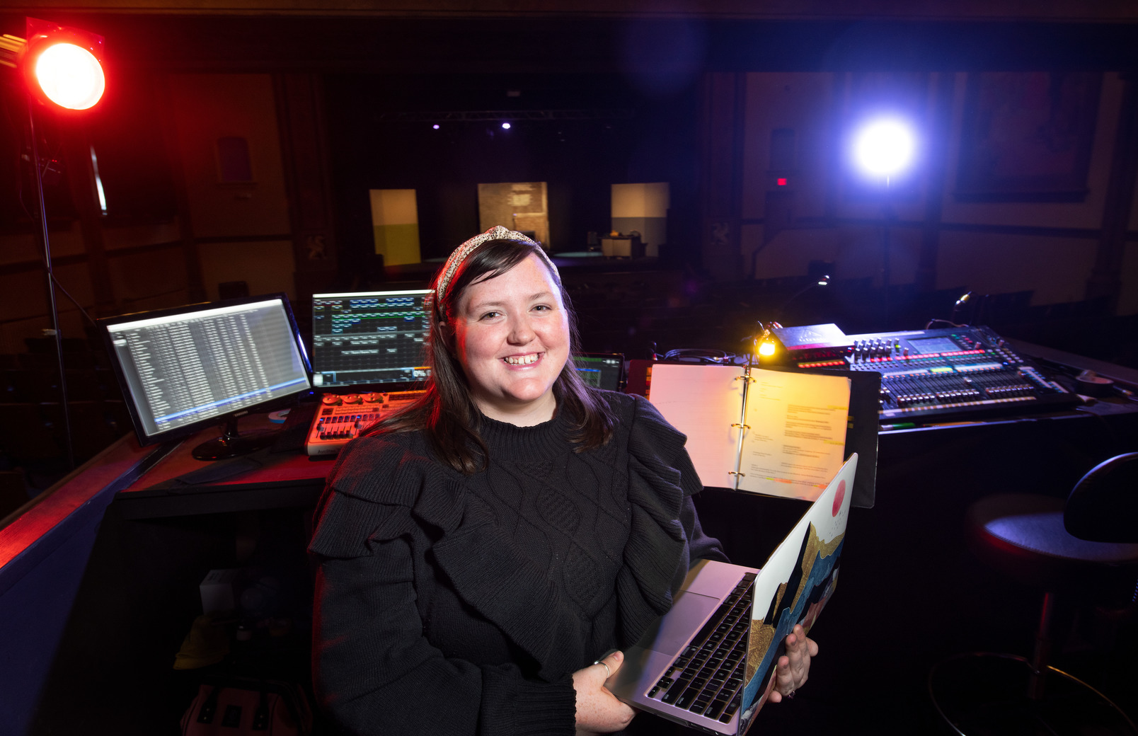 Student working in the technological booth for a theatre production