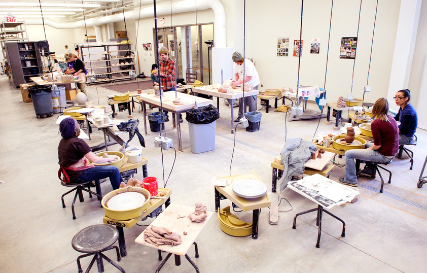 a group of students working in the ceramics studio