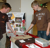 Two students at merchandise table