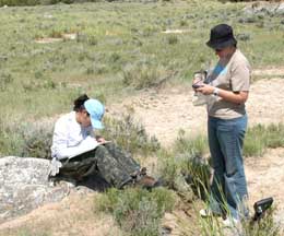 Two students working at restoration site