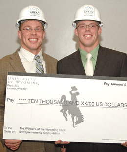 Two men holding oversized check