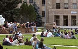 Several students sitting on lawn