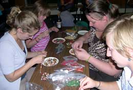 Group of children making jewelry