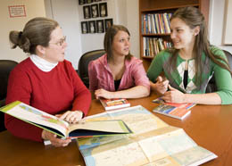 Three women looking at a book