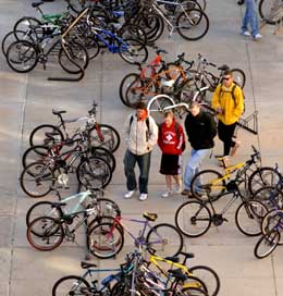 Students walk through haphazardly parked bicycles