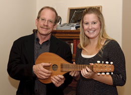 Man and woman holding small guitar