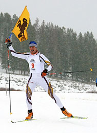 Skier holding University of Wyoming flag