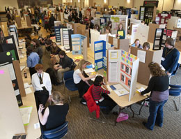 Crowd and exhibits at science fair