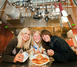 Three women displaying pancakes