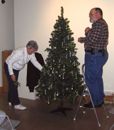 Two people decorating tree