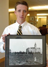 Man holding framed photograph