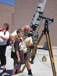Man and child using telescope