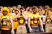 People wearing yellow-gold colored shirts