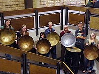 Seven people holding steel drums