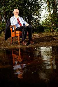 Man sitting next to pond