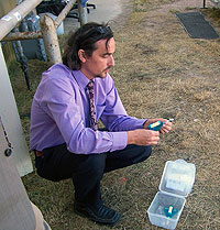 Man with air testing equipment