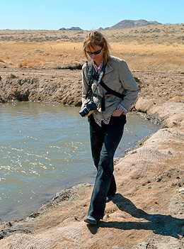 Woman walking next to body of water