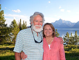 Man and woman standing in front of mountain