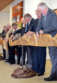 Group of people cutting a ribbon