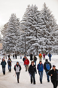 People walking on snowy sidewalk