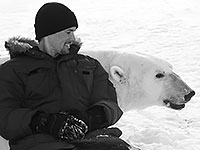 Man sitting next to polar bear
