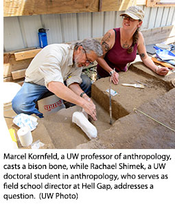 Marcel Kornfeld, a UW professor of anthropology, casts a bison bone, while Rachael Shimek, a UW doctoral student in anthropology, who serves as field school director at Hell Gap, addresses a question.