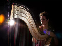 woman seated at harp
