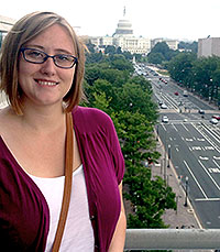 woman standing with United States Capitol building and street in background