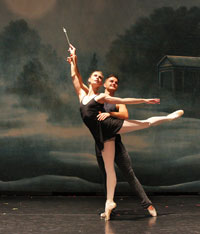 man and woman ballet dancers in a pose on stage