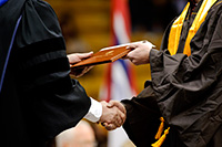 diploma being handed from one person to another