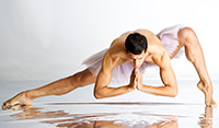 person in a stretched and bent over ballet pose