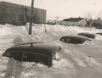 cars buried in snow up to their roofs