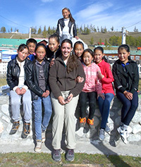 woman posing with a group of children