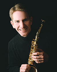 man holding saxophone