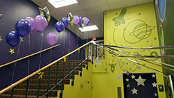 stair area decorated for party with balloons