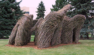 an abstract outdoor scupture made of woven sticks