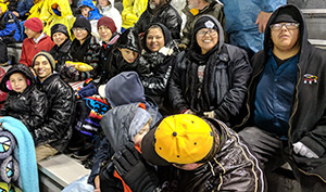 row of people seated at a football game