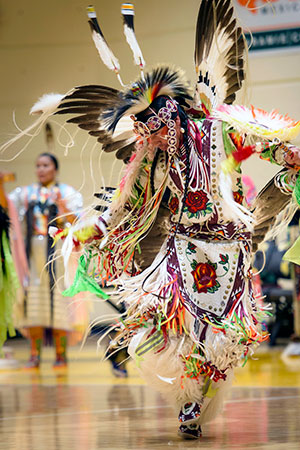 Native American man dancing in traditional costume