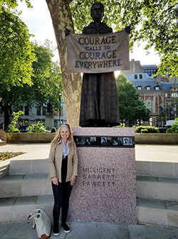 woman standing in front of a statue