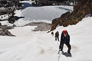 people climbing a snowy mountainside