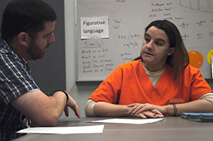 teacher talking with female prisoner