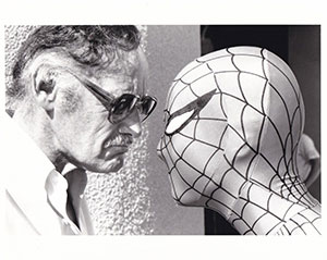 man and man in Spiderman costume staring at each other