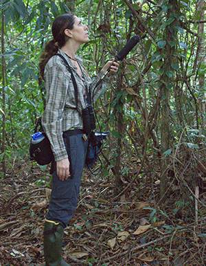 person in a jungle with a large microphone