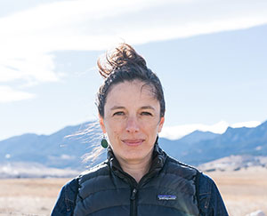 head shot of woman with mountains in background