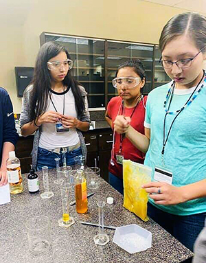 three teenage girls working in a lab