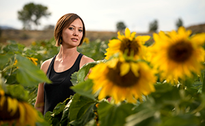 woman standing in field of sunflowers
